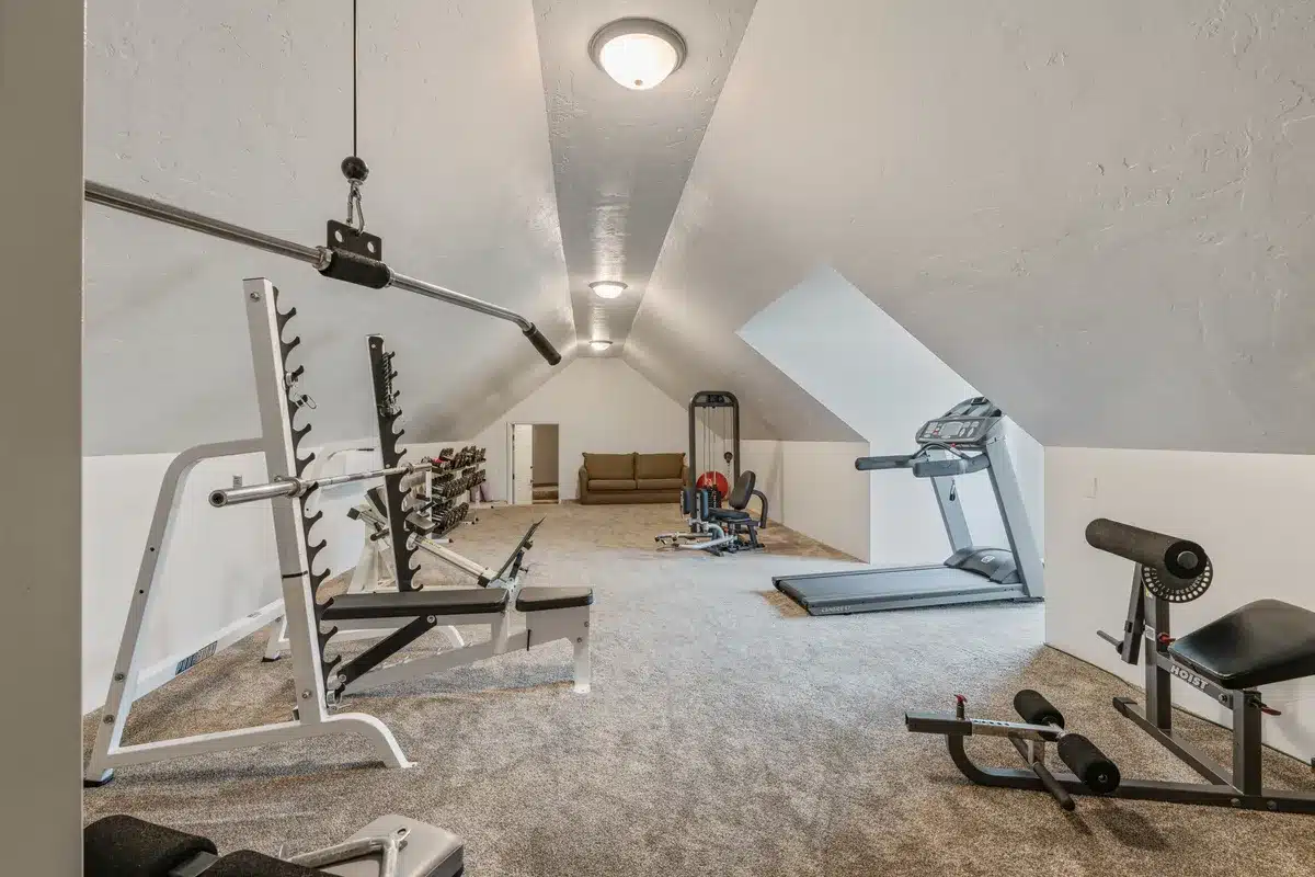 Workout room at Mansion on the Lake with treadmill, leg press, weight bench, and additional exercise equipment