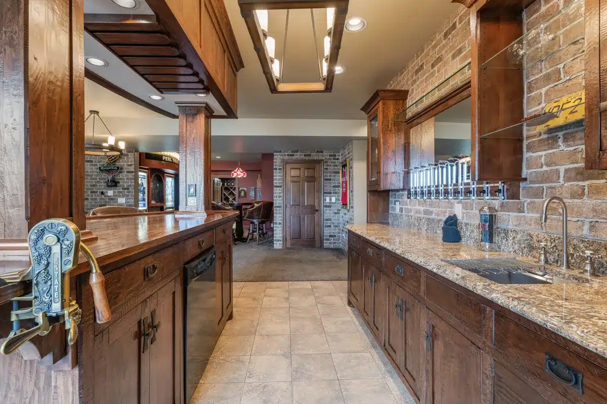 Fully equipped downstairs bar at Mansion on the Lake with refrigerator, wine opener, dishwasher, and glassware