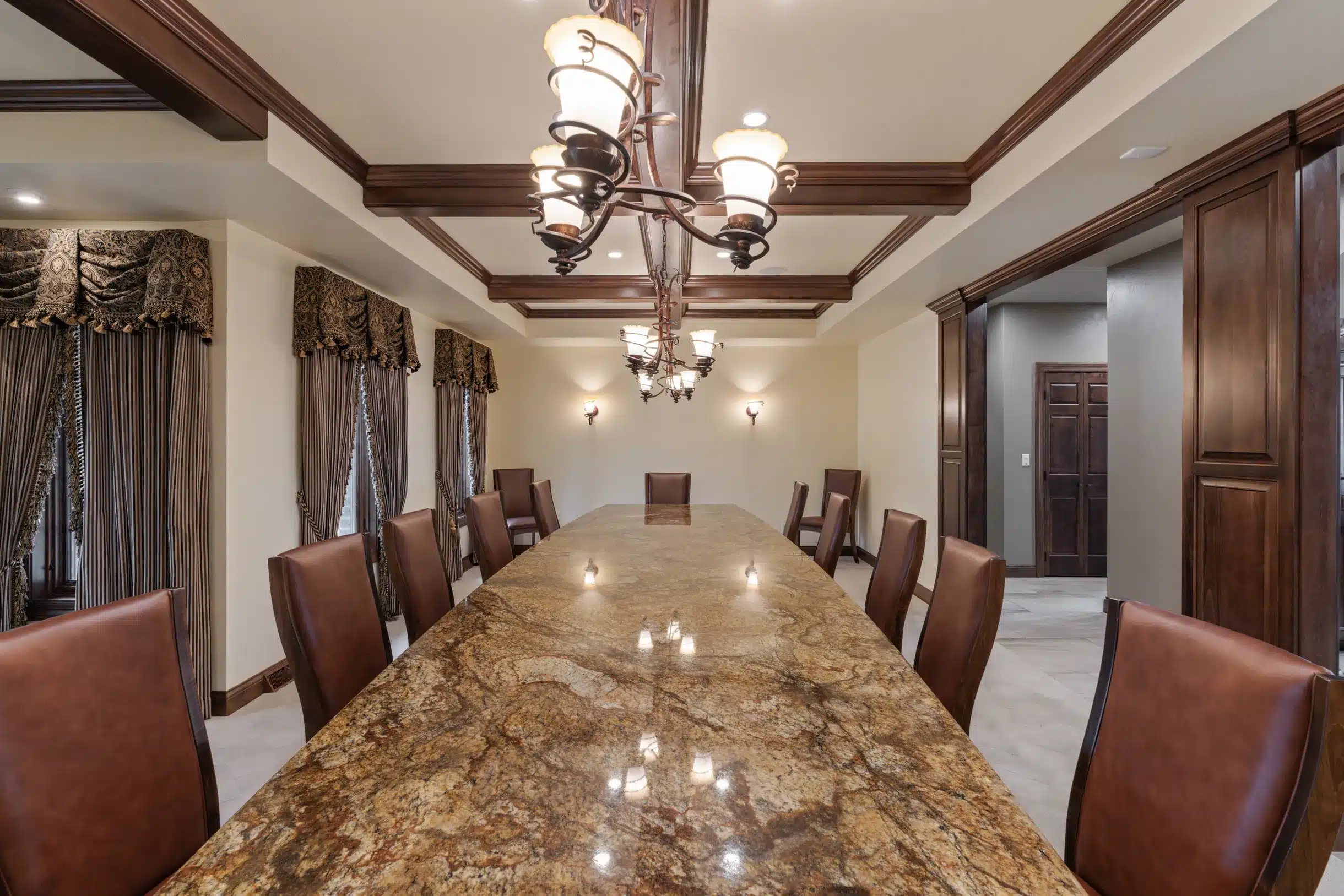 Elegant dining room at Mansion on the Lake with seating for 16, offering panoramic landscape views and sophisticated ambiance.