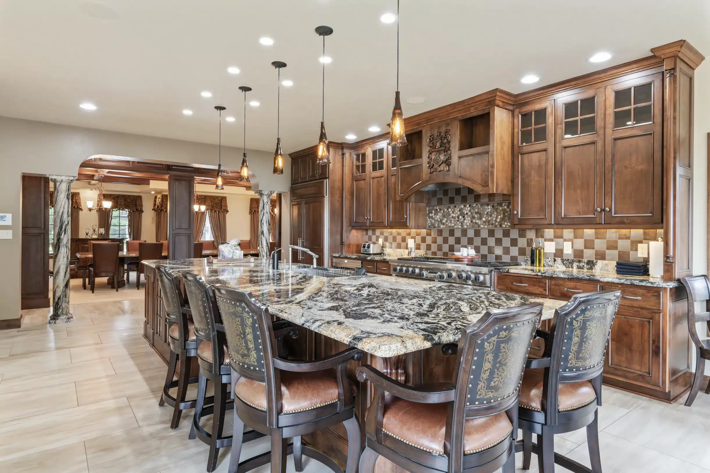 View of the elegant dining room from the kitchen at Mansion on the Lake in Newton, WI, featuring seating for 16 and luxury deco