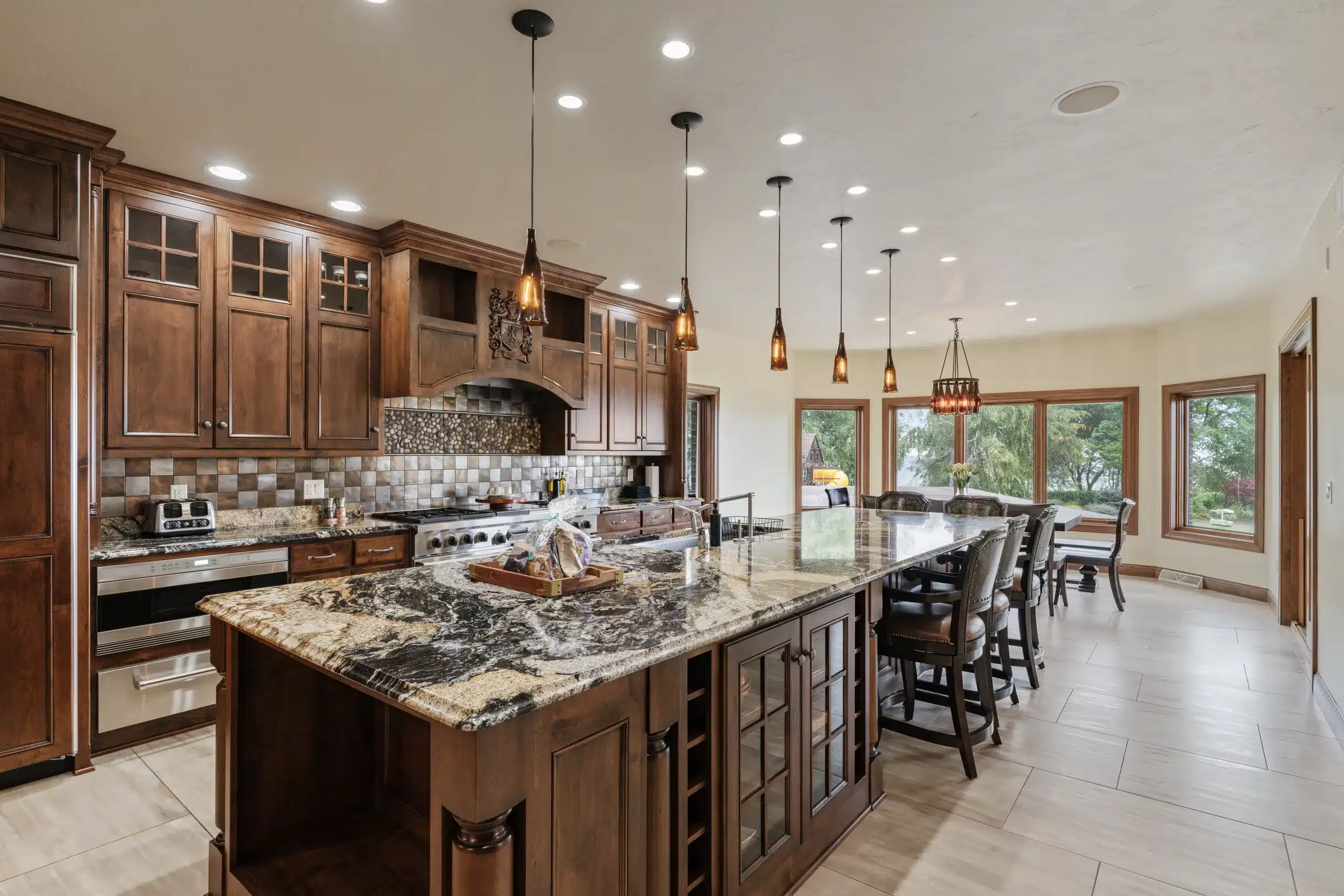 Gourmet kitchen with Wolf appliances, marble countertops, and chef’s tools at Mansion on the Lake in Newton, WI